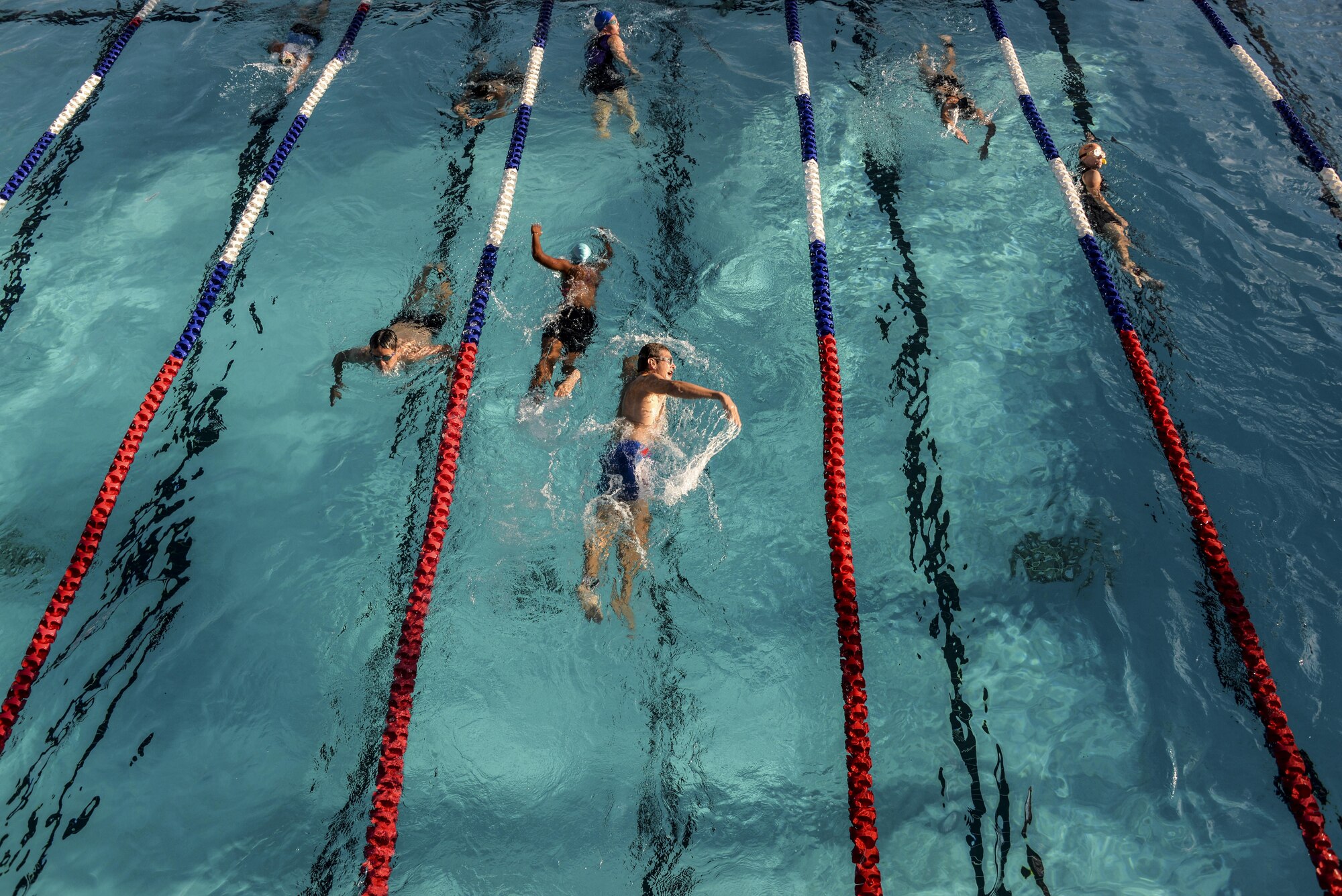 Team Luke triathlon participants swim during the Luke Triathlon held at Luke Air Force Base, Ariz., Aug. 19, 2017. Approximately 70 participants completed the swim before moving on to the biking and running portion of the event. (U.S. Air Force photo/Airman 1st Class Caleb Worpel)