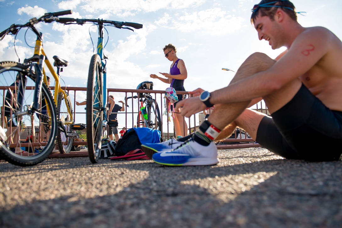 A Team Luke triathlon participant transitions to the bike during the Luke Triathlon held at Luke Air Force Base, Ariz., Aug. 19, 2017. The biking portion of the competition encompassed a total distance of 13 miles. (U.S. Air Force photo/Staff Sgt. Jensen Stidham)