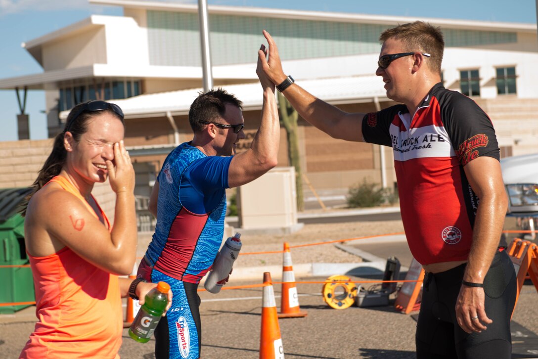 Team Luke triathlon participants celebrate after a triathlon held at Luke Air Force Base, Ariz., Aug. 19, 2017. Participants swam 400 meters, biked 13 miles and ran 3.1 miles to finish the competition. (U.S. Air Force photo/Staff Sgt. Jensen Stidham)