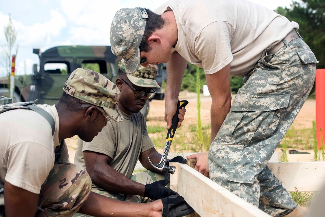 Soldiers construct a flooring system.