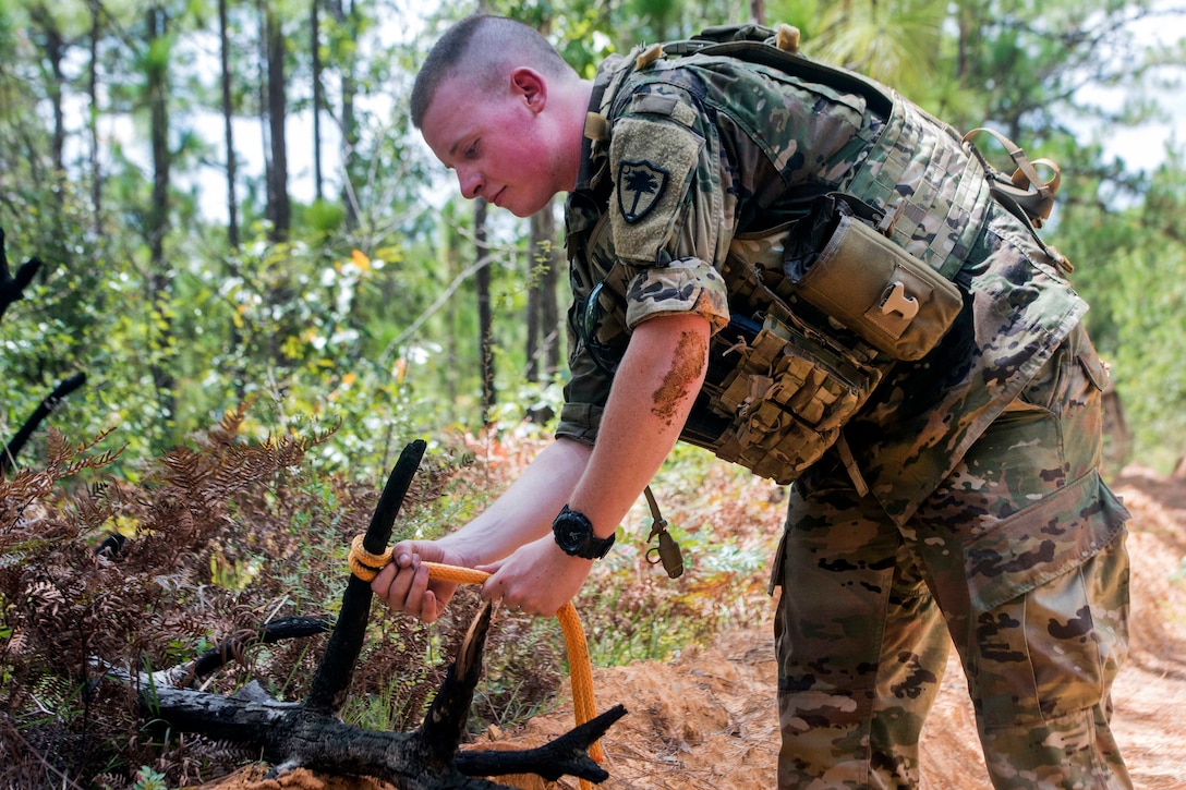 A soldier tests knot-tying techniques.