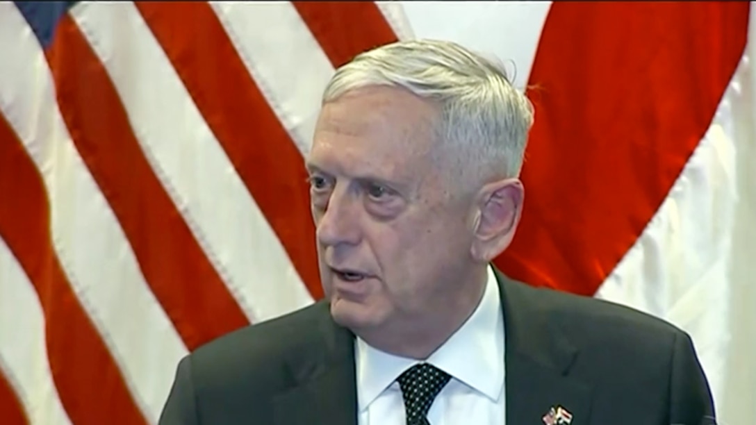 This screen shot shows Defense Secretary Jim Mattis speaking in front of a U.S. flag.