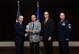 Stanley Marcum, National Air and Space Intelligence Center employee, receives the NASIC Wall of Honor award from Col. Sean Larkin, NASIC commander and Curt Rowland, NASIC chief scientist, here Aug. 15, 2015. The Wall of Honor is the greatest honor that NASIC can bestow on one of its alumni, It recognizes their significant achievements and is a reflection of their lasting, positive contributions to the center. (U.S. Air Force photo by Staff Sgt. Stephanie Longoria)