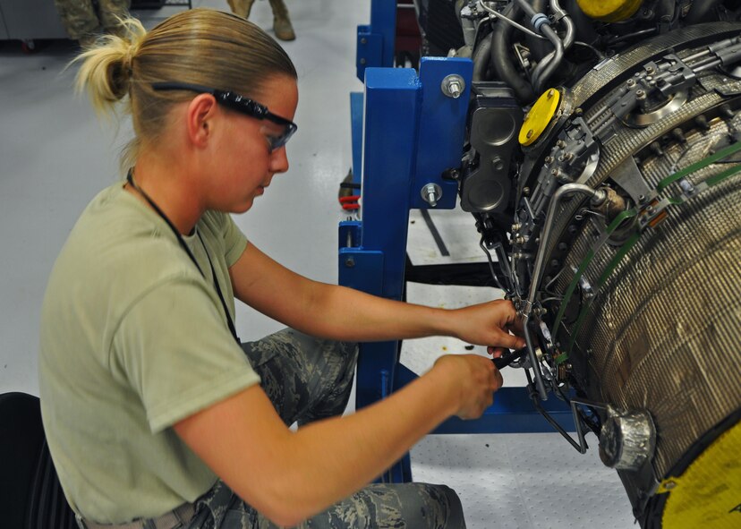 Maintainer works on C-146A engine at Duke Field, Fla.