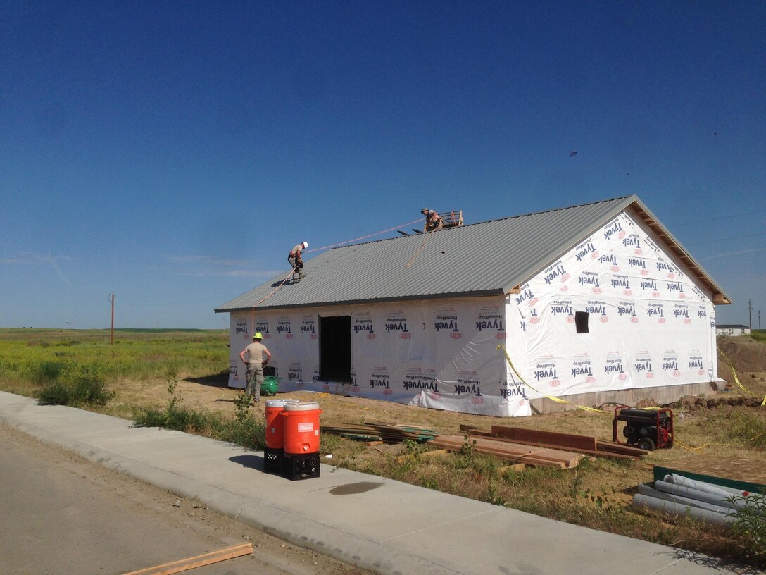 Members of the 106th Rescue Wing Civil Engineering assigned to the New York Air National Guard, work on the roof of a house that was left unfinished by a contractor at Crow Agency, Montana June 7, 2017. 32 members from the New York Air National Guard’s 106th Rescue Wing’s Civil Engineer Squadron and five members from the 106th Force Support Squadron, here, deployed for training June 4 to June 17, 2017, at Crow Agency, Montana, in an effort to build and renovate homes for military service veterans from the Native American tribe Crow Nation. (U.S. Air Force photo by Maj. Ronnie Maloney)