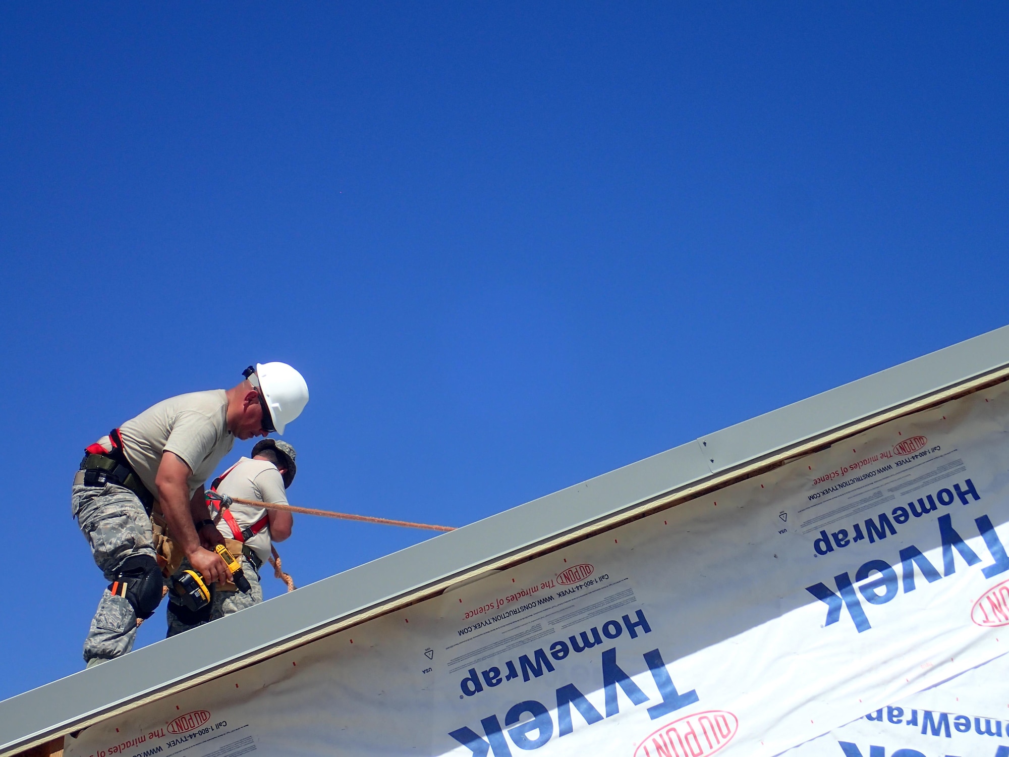 Members of the 106th Rescue Wing Civil Engineering assigned to the New York Air National Guard, work on the roof of a house that was left unfinished by a contractor at Crow Agency, Montana June 7, 2017. 40 to 60 members from National Guard Civil Engineer Squadron throughout the country will deploy to help renovate and build six homes that were left unfinished in various stages by a contractor. (U.S. Air Force photo by Senior Airman Vincent Naimo)