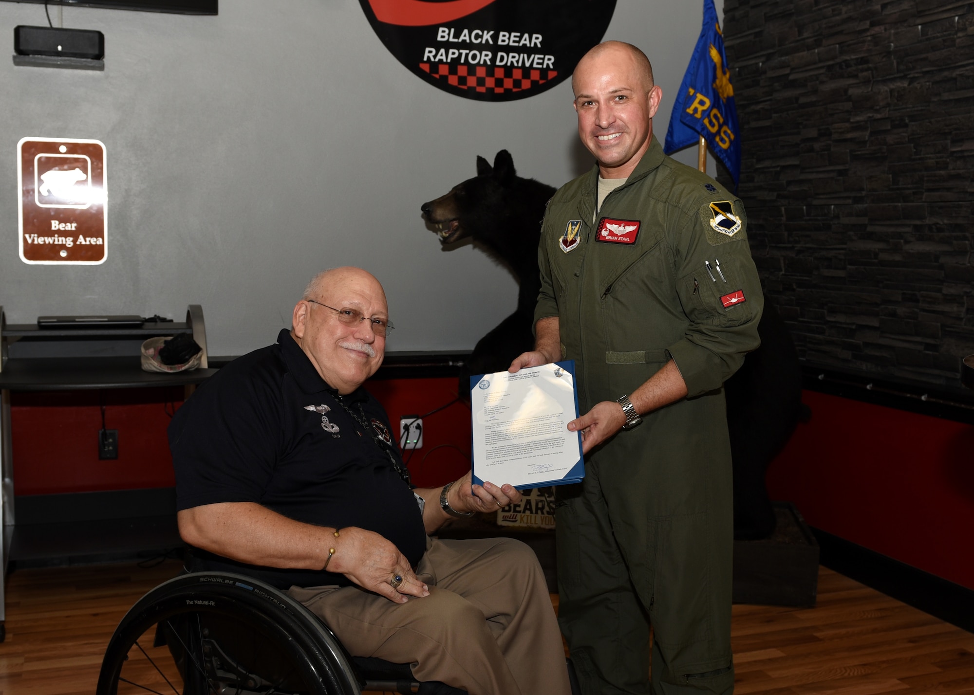 U.S. Air Force Lt. Col. Brian Stahl, 325th Training Support Squadron commander, presents Skip Sanders, 325th TRSS air combat maneuvering instrumentation functional director, an award during a recognition ceremony at Tyndall Air Force Base, Fla., Aug. 17, 2017. The award is to recognize Sanders for reaching 40 years of service in support of the U.S. government. The 325th TRSS manages training resources and conducts unrivaled academic and realistic simulator training to produce America's air dominance team of F-22 Raptor pilots, air battle managers and intelligence officers for worldwide assignments.
