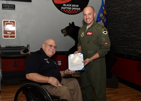 U.S. Air Force Lt. Col. Brian Stahl, 325th Training Support Squadron commander, presents Skip Sanders, 325th TRSS air combat maneuvering instrumentation functional director, an award during a recognition ceremony at Tyndall Air Force Base, Fla., Aug. 17, 2017. The award is to recognize Sanders for reaching 40 years of service in support of the U.S. government. The 325th TRSS manages training resources and conducts unrivaled academic and realistic simulator training to produce America's air dominance team of F-22 Raptor pilots, air battle managers and intelligence officers for worldwide assignments.