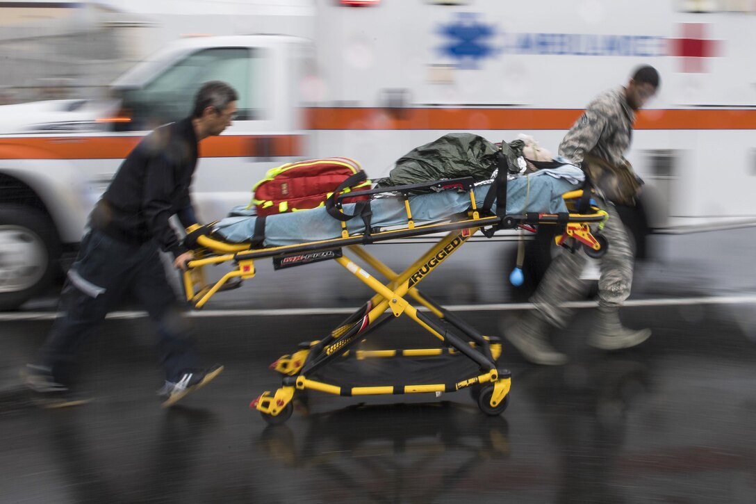 Emergency responders transport a simulated victime during an active shooter exercise.