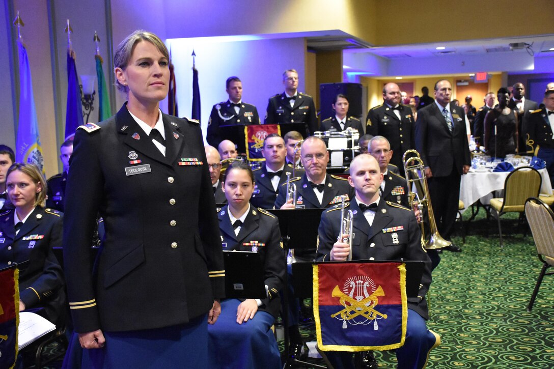 88th Regional Support Command Army Band member CW3 Sharon Toulouse stands at attention after conducting a performance during an 88th RSC Headquarters and Headquarters Company banquet in Warrens, Wis. on Aug. 19, in honor of the 100 Year Anniversary of the establishment of the 88th Division.