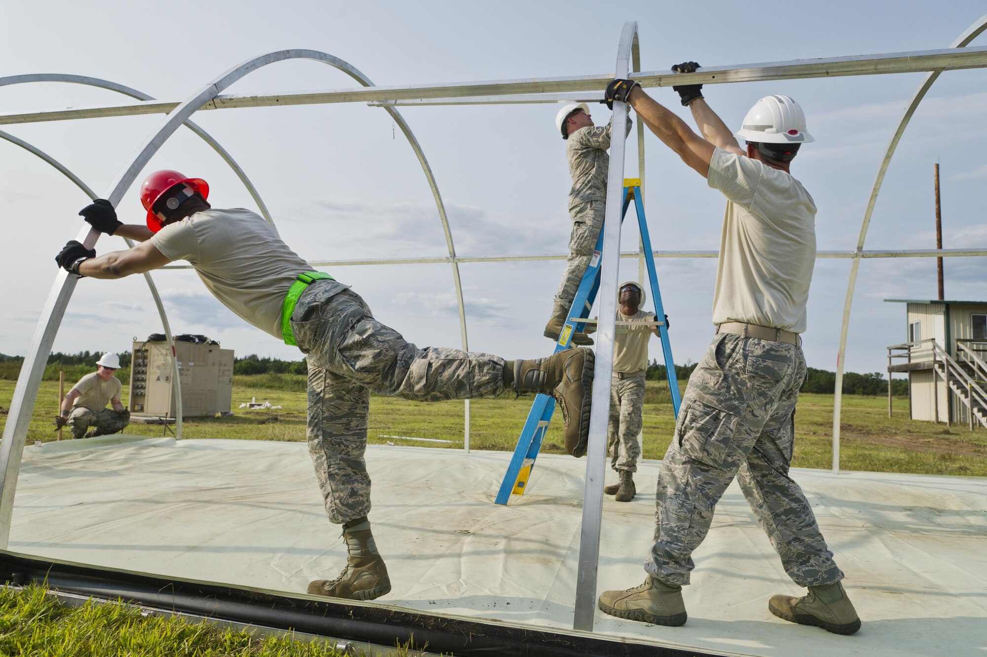 U.S. Air Force personnel assigned to the 302nd Civil Engineer Squadron, Peterson AFB, Colo., and 307th Civil Engineer Squadron, Barksdale AFB, La., assemble the framework of a Small Shelter System for a bare base setup at Young Air Assault Strip, Fort McCoy, Wis., during exercise Patriot Warrior, Aug. 5, 2017.