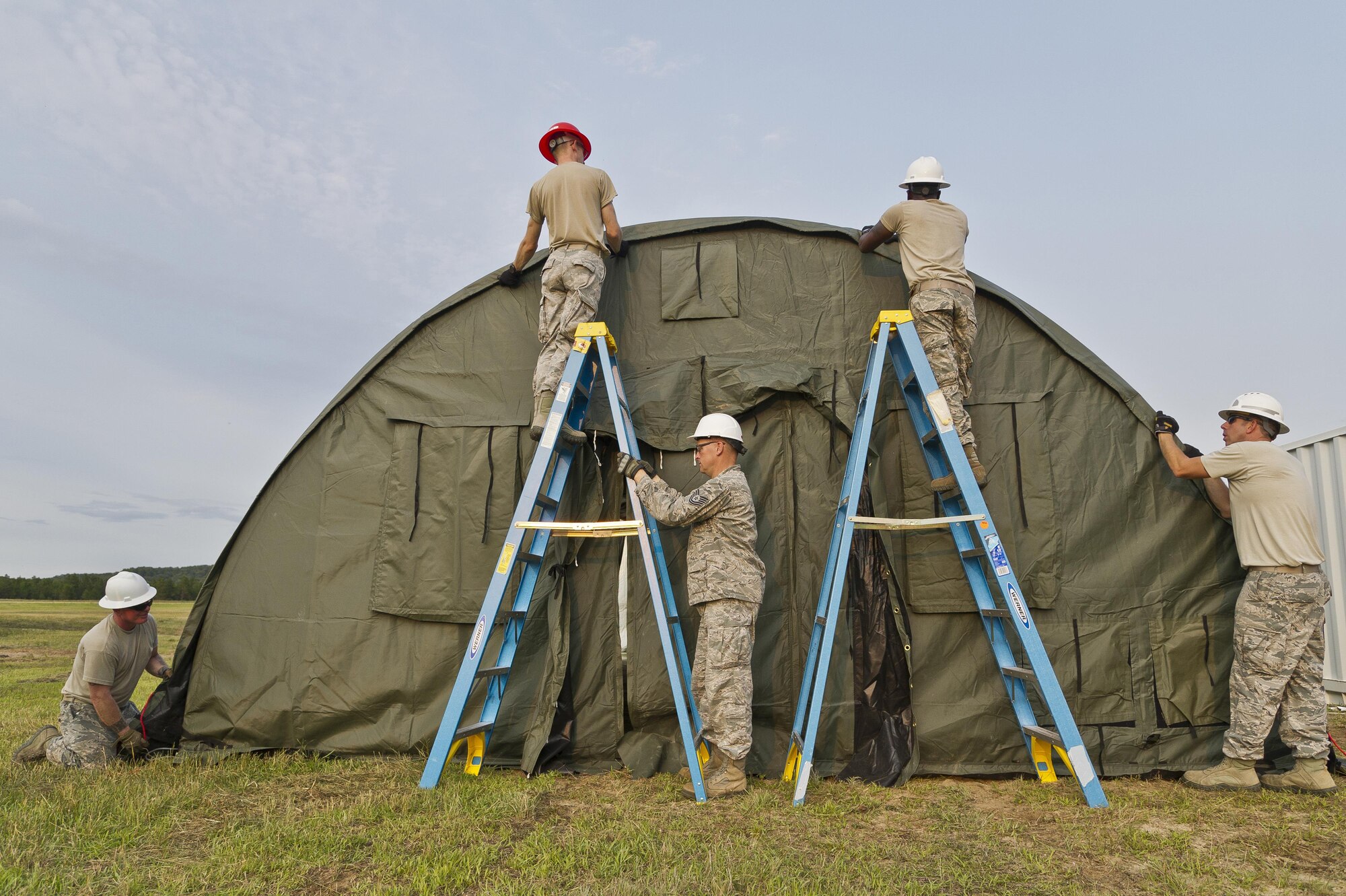 U.S. Air Force personnel assigned to the 302nd Civil Engineer Squadron, Peterson AFB, Colo., and 307th Civil Engineer Squadron, Barksdale AFB, La., assemble a Small Shelter System for a bare base setup at Young Air Assault Strip, Fort McCoy, Wis., during exercise Patriot Warrior, Aug. 5, 2017.