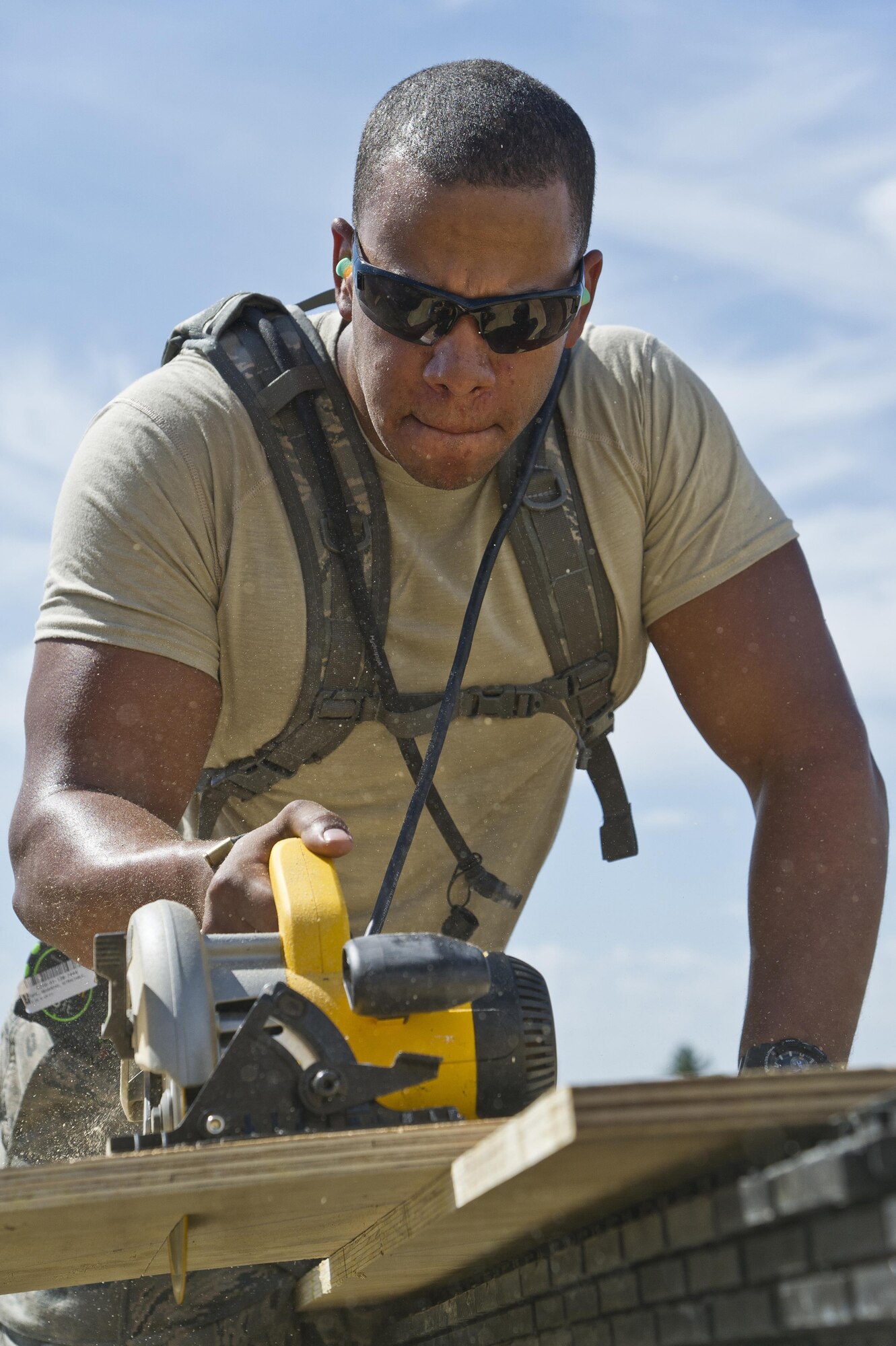 U.S. Air Force Senior Airman Christopher Clater, 307th Civil Engineer Squadron, Barksdale AFB, La., cuts a piece of plywood to build a box for storing power cords during  exercise Patriot Warrior at Young Air Assault Strip, Fort McCoy, Wis., Aug. 9, 2017.