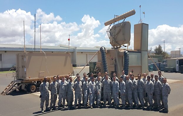 297th Air Traffic Control Squadron, Hawaii Air National Guard’s Airmen pose for a group picture in front of a Meteorological Rader Navigation Model 14K, mobile radar ground approach system, at Kapolei, Hawaii July 18, 2014. The 297th is a critical unit in the Pacific trained to provide air traffic control functions, anywhere in the world, at a moment’s notice. (Courtesy Photo)