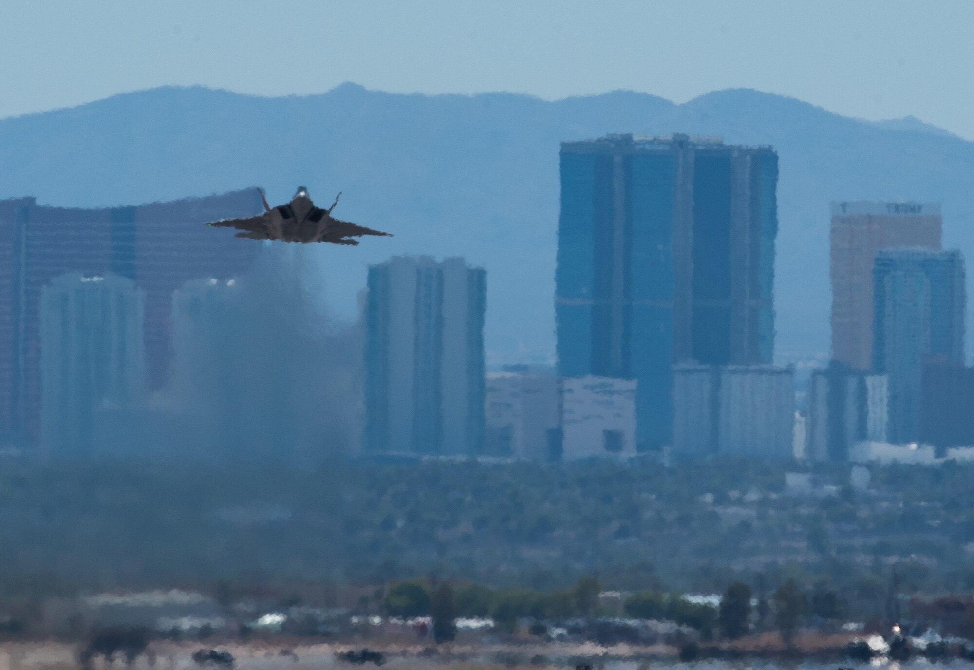 An 94th Fighter Squadron F-22 Raptor takes off with the Las Vegas, Nev. Skyline behind it during Red Flag 17-4 at Nellis Air Force Base, Nev., Aug. 17, 2017. (U.S. Air Force photo by Staff Sgt. Carlin Leslie)