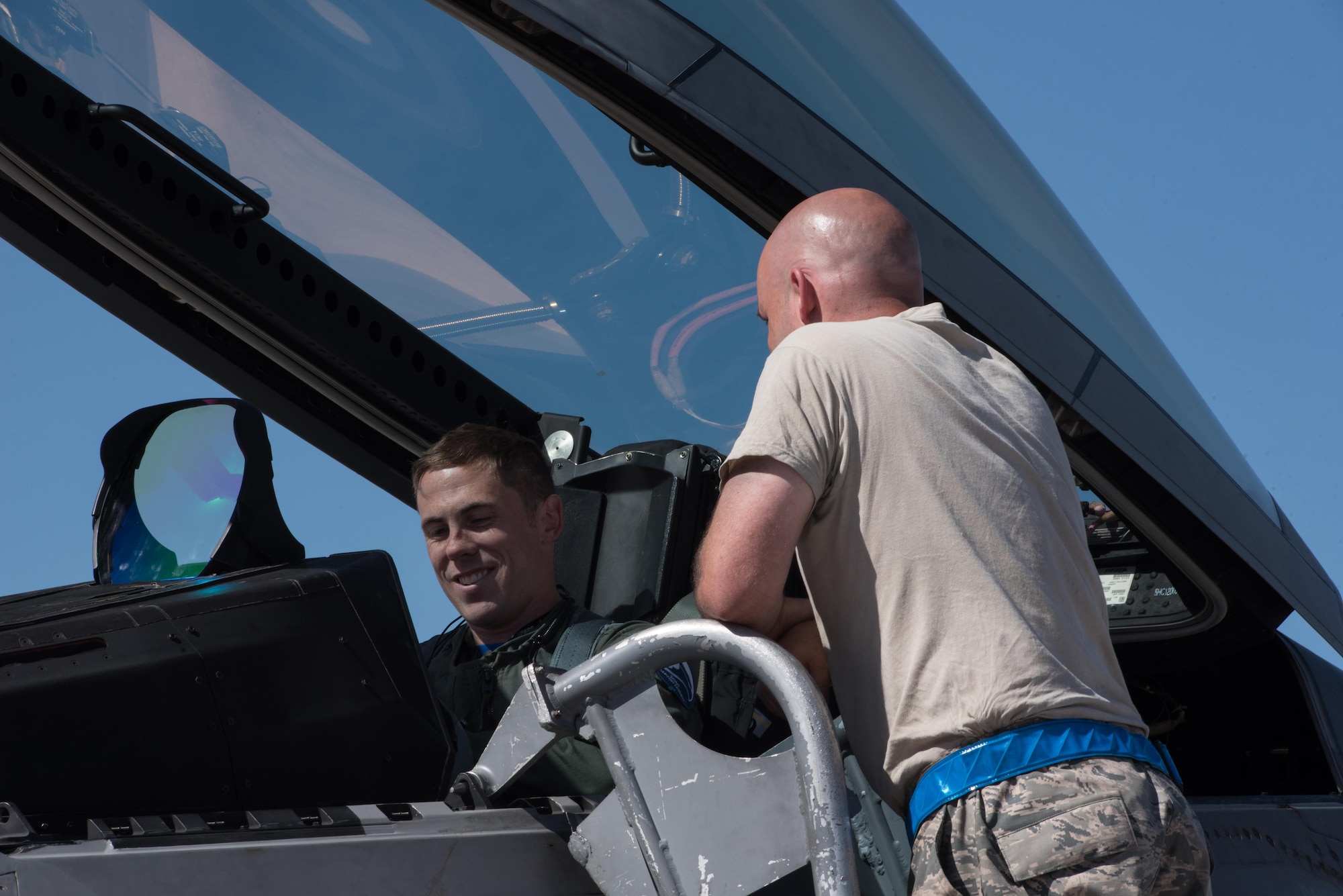 U.S Air Force Capt. Kidnap, 94th Fighter Squadron F-22 Raptor pilot speaks with U.S. Air Force Staff Sgt. Courtney Puyear, 94th Aircraft Maintenance Unit crew chief, after landing at Nellis Air Force Base, Nev. Aug. 18, 2017.  The 94th FS is currently deployed to Red Flag 17-4, taking part in an multi-dimensional simulated air and ground combat environment. (U.S. Air Force photo by Staff Sgt. Carlin Leslie)
