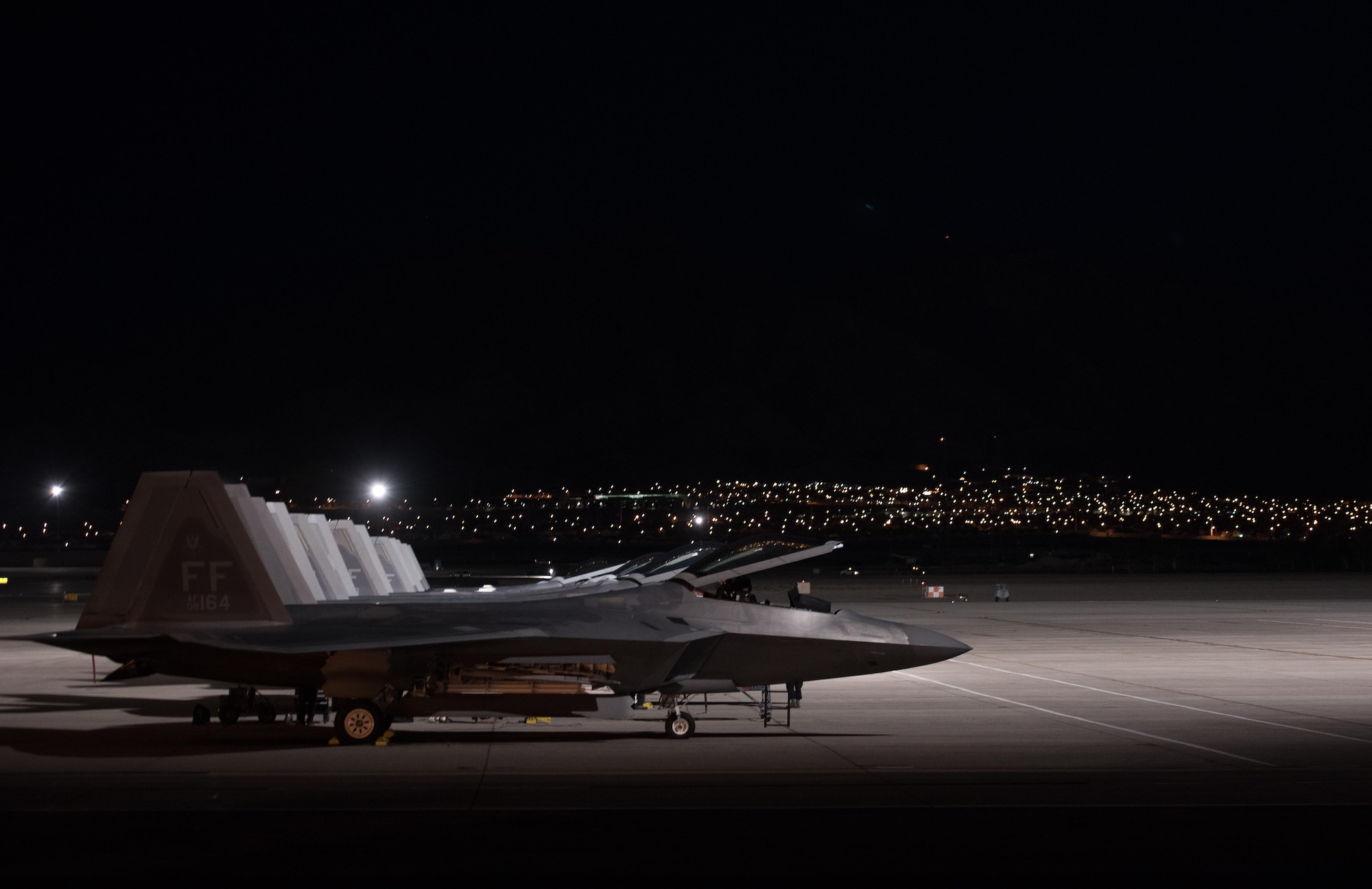 U.S. Air Force F-22 Raptors are at the ready for the night mission at Red Flag 17-4 at Nellis Air Force Base, Nev., Aug. 21, 2017.  During the mission Capt. Flash, 94th Fighter Squadron pilot, will complete his mission commander upgrade certification. (U.S. Air Force photo by Staff Sgt. Carlin Leslie)
