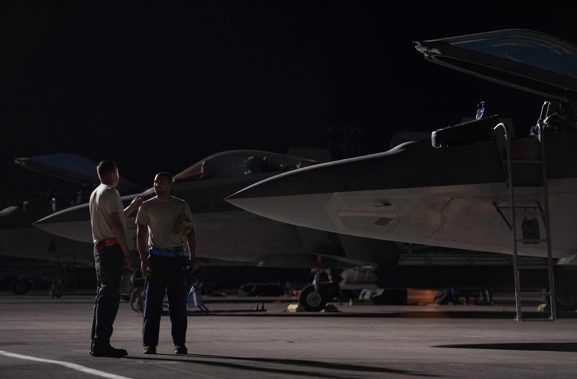 U.S Air Force Tech. Sgt. William Marioth, 192nd Aircraft Maintenance Squadron and Staff Sgt. Jonathon Millan, 94th Aircraft Maintenance Unit crew chiefs, discuss shift change during Red Flag 17-4 at Nellis Air Force Base, Nev., Aug. 21, 2017. The deployed maintenance unit to Red Flag is comprised of Airmen from the 94th Aircraft Maintenance Unit, 27th Maintenance Unit and the 192nd Aircraft Maintenance Squadron, making the team total force integrated as one effort.  (U.S. Air Force photo by Staff Sgt. Carlin Leslie)