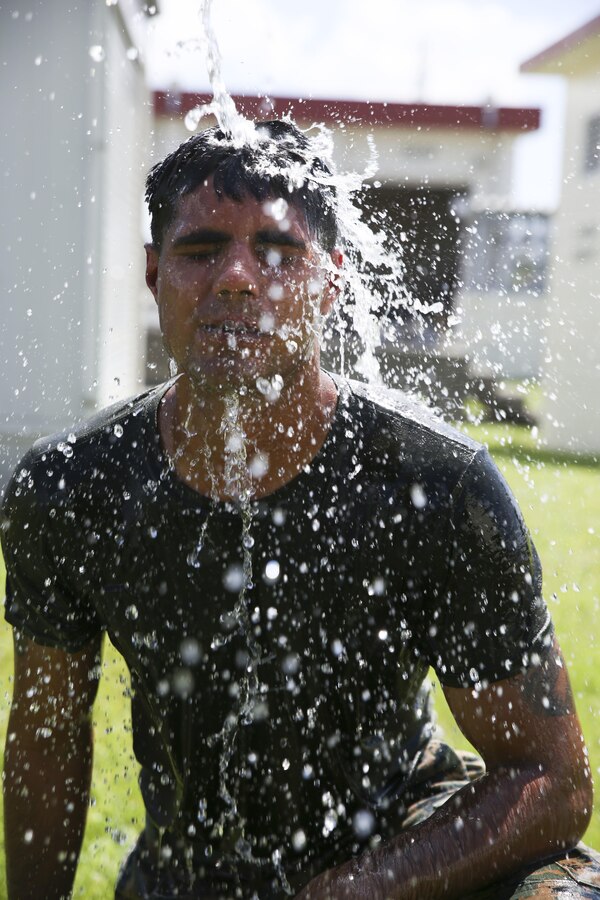 Lance Cpl. Anthony Compton, a water purification specialist with Engineer Platoon, III Marine Expeditionary Force Headquarters Group, rinses his face after completing an oleoresin capsicum fight-through drill during non-lethal weapons training August 16, 2017. Compton is currently assigned as an augment to Camp Guard on Camp Hansen, Okinawa, Japan, where he provides support to the base Provost Marshall Office and Marine Corps Police Department. Compton is a native of Beaufort, North Carolina. (U.S. Marine Corps photo by Sgt. Tiffany Edwards)