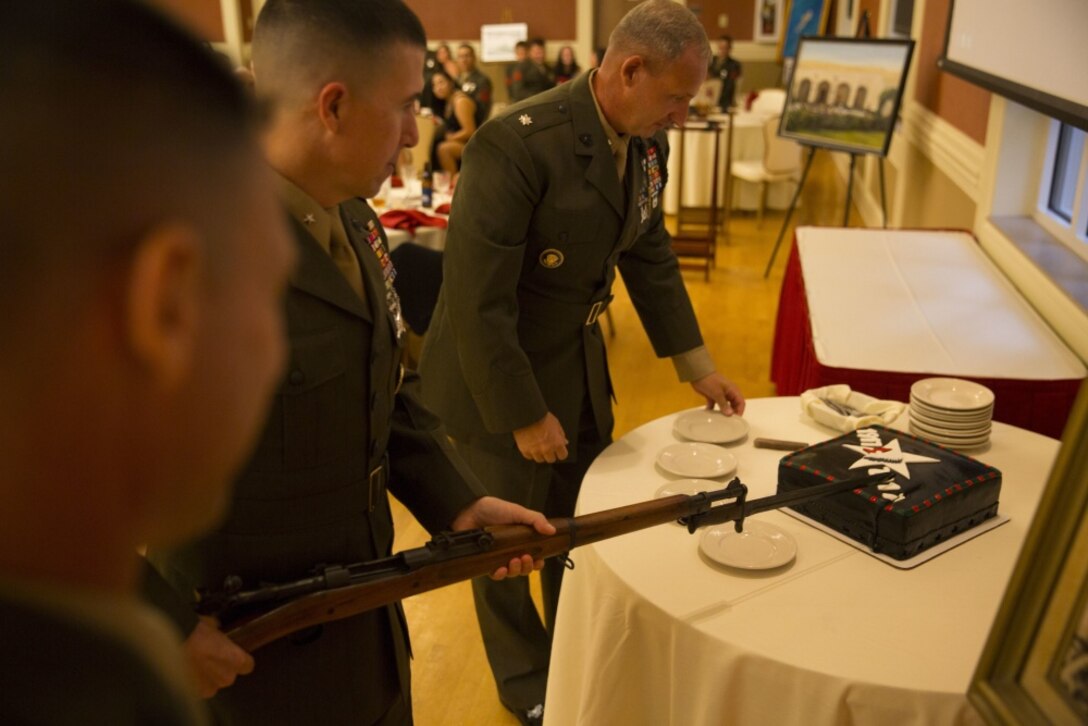 Brig. Gen. Benjamin Watson cuts the ceremony’s cake with a bayonet during a dinner for 6th Marine Regiment at Camp Lejeune, N.C., on Aug. 18, 2017.