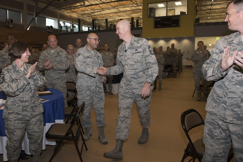 Command Chief of the Air National Guard, Chief Master Ronald C. Anderson greets Airmen as he enters the auditorium for the Enlisted Leadership Symposium at Camp Dawson, W.Va., Aug. 15-17. Nearly 350 Airmen representing Air National Guard units from each state, territory and the District of Columbia, attended the event, hosted by the Command Chief of the Air National Guard, Chief Master Ronald Anderson. The three-day event focused on leadership and professional development. Airmen, non-commissioned officers and senior non-commissioned officers were hand-selected by their units to attend the event. (U.S. Air National Guard photo/Senior Master Sgt. Emily Beightol-Deyerle)