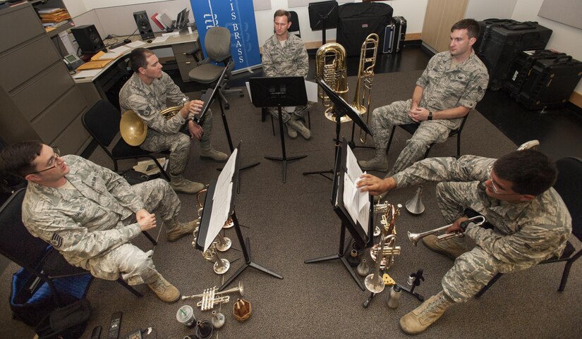 Members of the Travis Brass Quintet pause in the middle of a rehearsal to discuss how to play a single bar of music Aug. 7, 2017 at Travis Air Force Base Calif.  Band members will rehearse at several sessions for weeks or months, two to three hours at a time until the performance is perfect.  One of the cornerstone ensembles for the Band of the Golden West, Travis Brass has been delighting audiences in the Western U.S. for several decades. The brass quintet is made up of two trumpets, a horn, a trombone and a tuba.