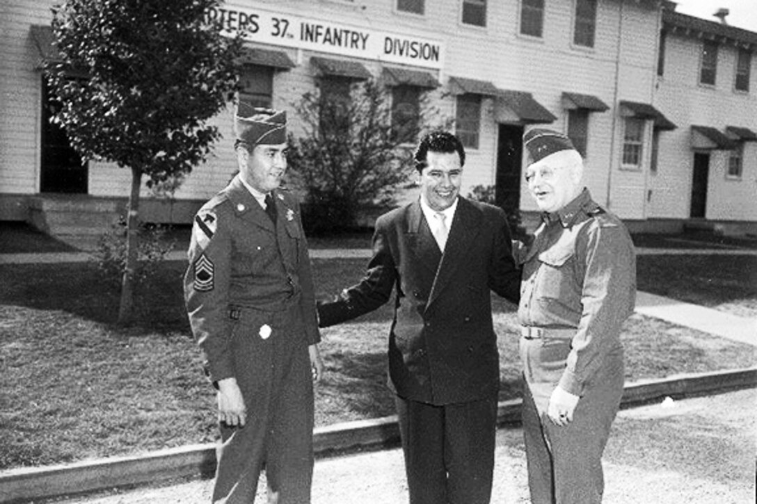 Three soldiers stand together.