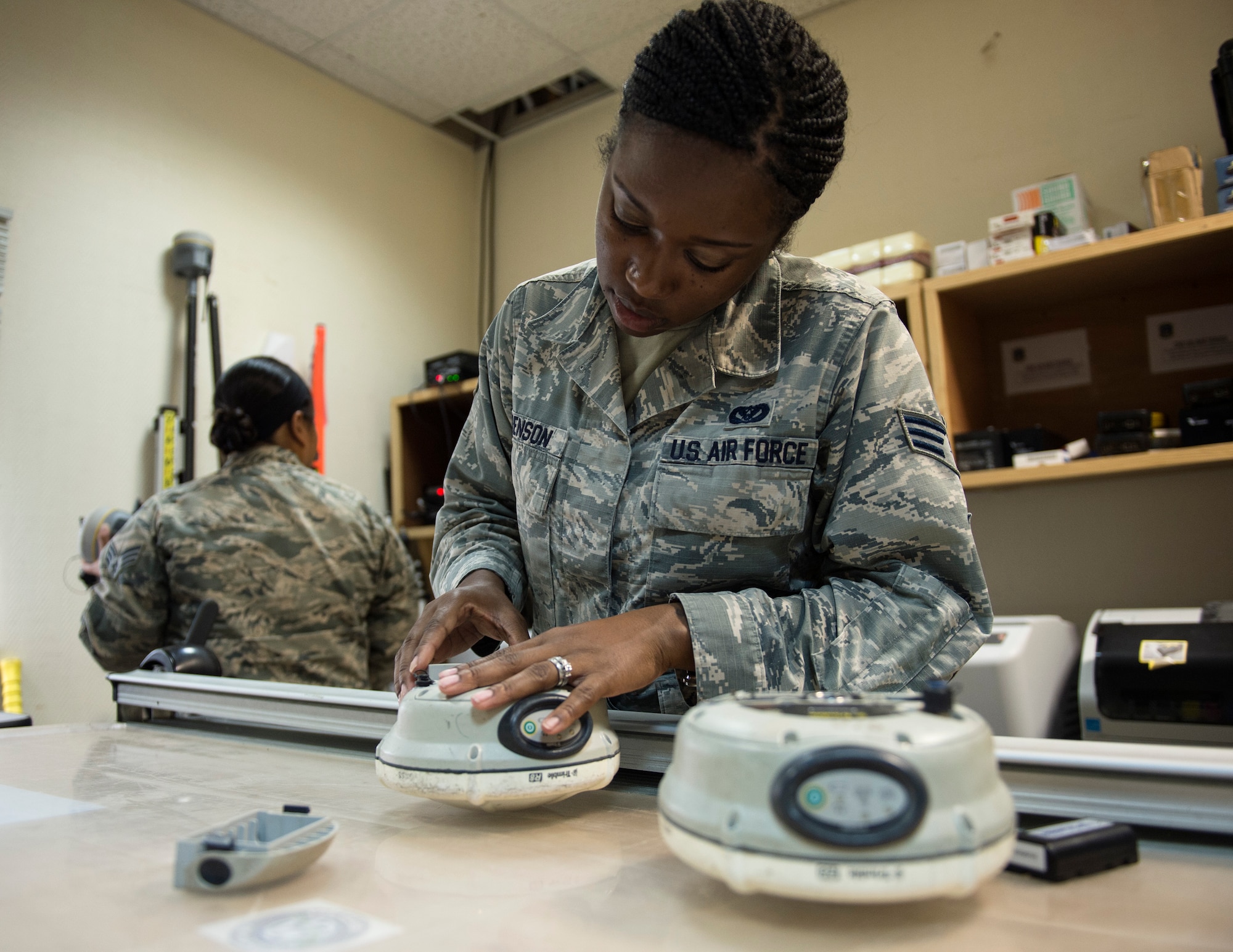 U.S Air Force Senior Airman Dalicia Brenson, an engineering technician with the 379th Expeditionary Civil Engineer Squadron, assembles a Trimble GPS Land Surveying Equipment at Al Udeid Air Base, Qatar, July 25, 2017.