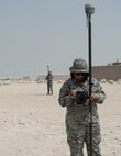 U.S Air Force Senior Airman Zamantha Tinio, front, an expeditionary geobase manager and Senior Airman Dalicia Brenson, an engineering technician with the 379th Expeditionary Civil Engineer Squadron, record the coordinates and elevations on the Trimble GPS Land Surveying Equipment at Al Udeid Air Base, Qatar, Aug. 2, 2017. The Trimble GPS Land Surveying Equipment helps the engineering team to locate the exact coordinates and elevations for future construction projects.  (U.S. Air Force photo by Tech. Sgt. Amy M. Lovgren)