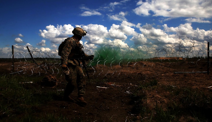 A U.S. Marine with Black Sea Rotational Force 17.1 sets down a detonation cord during an explosive breach drilll aboard Adazi Military Base, Latvia, June 8, 2017. The event was a part of Exercise Saber Strike 17, a multinational training exercise with NATO Allies and partner nations to increase cohesion and skills through combined-arms training (U.S. Marine Corps photo by Cpl. Sean J. Berry)