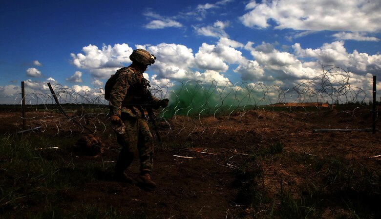 A U.S. Marine with Black Sea Rotational Force 17.1 sets down a detonation cord during an explosive breach drilll aboard Adazi Military Base, Latvia, June 8, 2017. The event was a part of Exercise Saber Strike 17, a multinational training exercise with NATO Allies and partner nations to increase cohesion and skills through combined-arms training (U.S. Marine Corps photo by Cpl. Sean J. Berry)