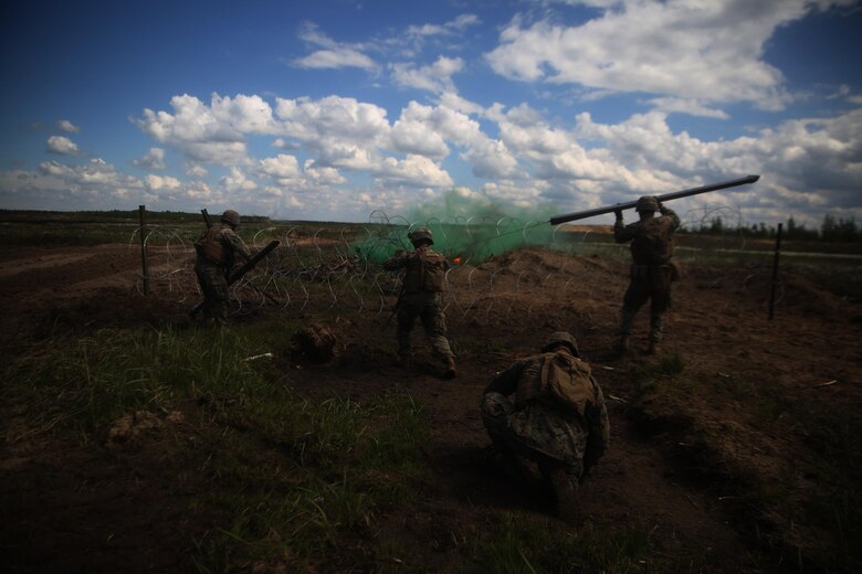 A U.S. Marine with Black Sea Rotational Force 17.1 charges an explosive breach aboard Adazi Military Base, Latvia, June 8, 2017. The event was a part of Exercise Saber Strike 17, a multinational training exercise with NATO Allies and partner nations to increase cohesion and skills through combined-arms training (U.S. Marine Corps photo by Cpl. Sean J. Berry)