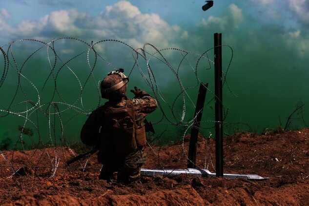 A U.S. Marine with Black Sea Rotational Force 17.1 tosses a smoke grenade during a breach drill aboard Adazi Military Base, Latvia, June 9, 2017. The event was a part of Exercise Saber Strike 17, a multinational training exercise with NATO Allies and partner nations to increase cohesion and skills through combined-arms training (U.S. Marine Corps photo by Cpl. Sean J. Berry)
