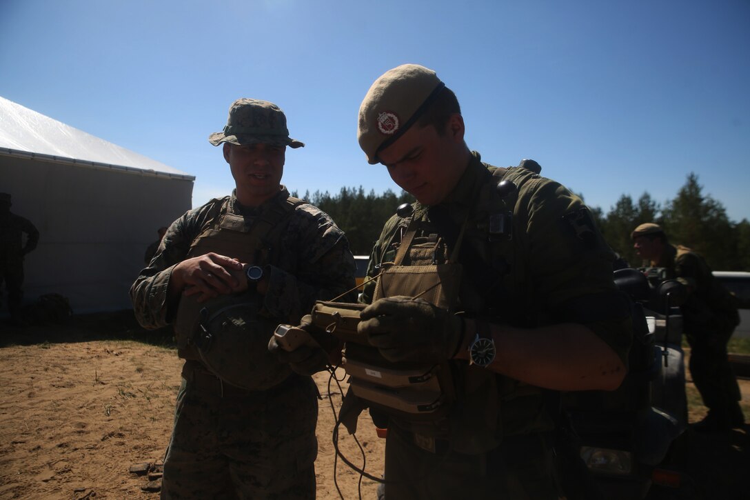 A U.S. Marine with Black Sea Rotational Force 17.1 tosses a smoke grenade during a breach drill aboard Adazi Military Base, Latvia, June 9, 2017. The event was a part of Exercise Saber Strike 17, a multinational training exercise with NATO Allies and partner nations to increase cohesion and skills through combined-arms training (U.S. Marine Corps photo by Cpl. Sean J. Berry)