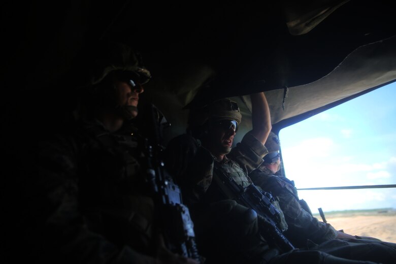 A U.S. Marine with Black Sea Rotational Force 17.1  and Royal British Marine ride together in a High Mobility Multipurose Wheeled Vehicle after an explosive breach aboard Adazi Military Base, Latvia, June 9, 2017. The event was a part of Exercise Saber Strike 17, a multinational training exercise with NATO Allies and partner nations to increase cohesion and skills through combined-arms training (U.S. Marine Corps photo by Cpl. Sean J. Berry)