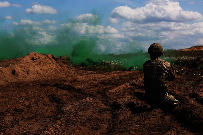 A U.S. Marine with Black Sea Rotational Force 17.1 tosses a smoke grenade during a breach drill aboard Adazi Military Base, Latvia, June 9, 2017. The event was a part of Exercise Saber Strike 17, a multinational training exercise with NATO Allies and partner nations to increase cohesion and skills through combined-arms training (U.S. Marine Corps photo by Cpl. Sean J. Berry)