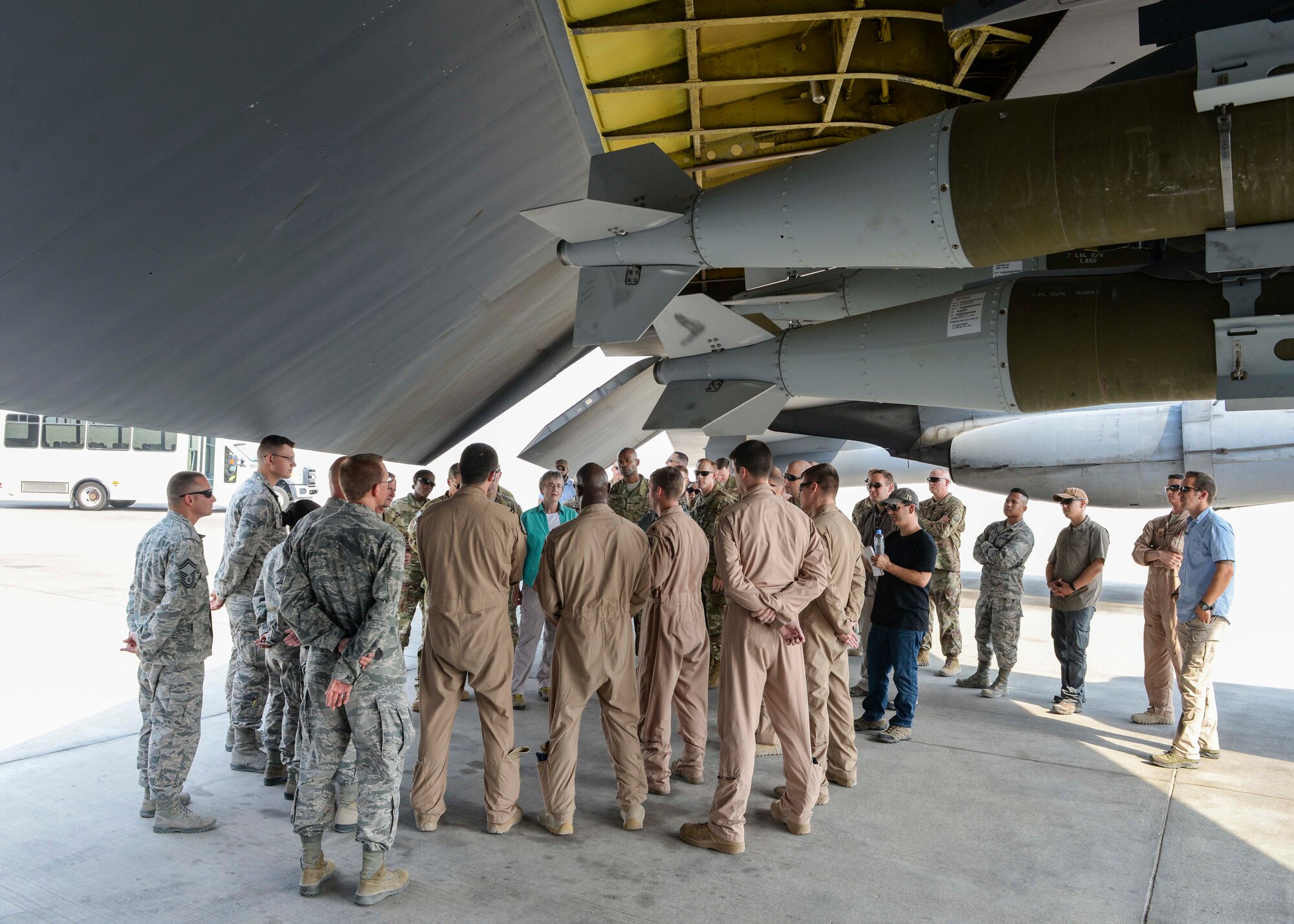 Secretary of the Air Force Heather Wilson speaks with Airmen assigned to the 23rd Expeditionary Bomb Squadron and the 379th Expeditionary Aircraft Maintenance Squadron under the wing of a B-52 Stratofortress at Al Udeid Air Base, Qatar, Aug. 15, 2017