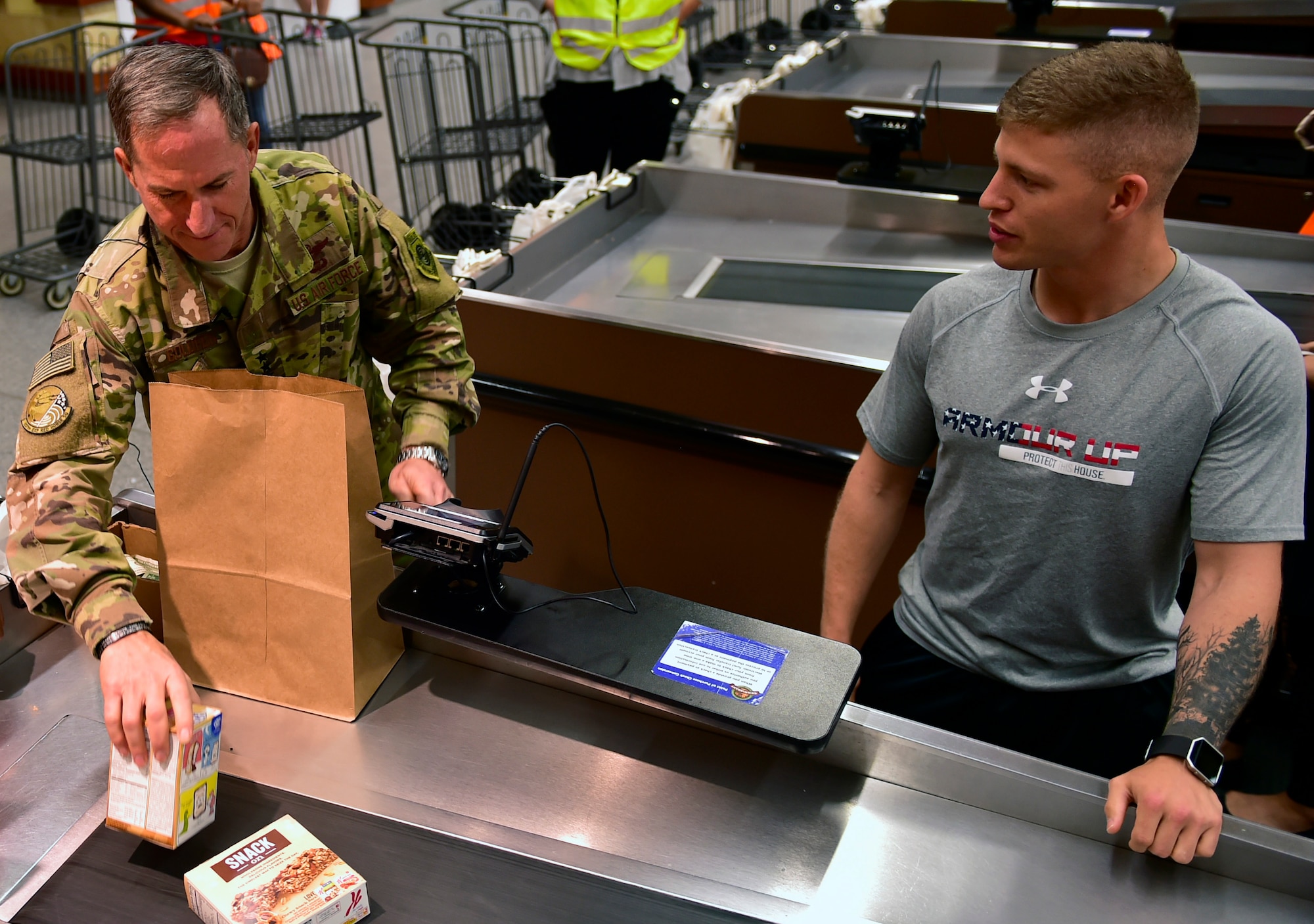 Air Force Chief of Staff Gen. David L. Goldfein bags groceries for an Airman at the commissary on Ramstein Air Base, Germany, Aug. 21, 2017. Gen. Goldfein worked as a bagger at the Ramstein commissary as a teenager. He passed through Ramstein on his way back to the states after visiting Airmen at several locations in the Middle East.