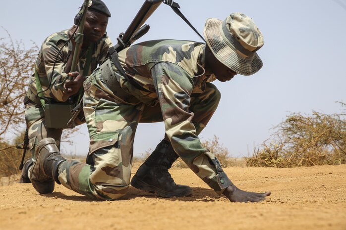 Soldiers with Senegal’s 5th Contingent in Mali search for potential improvised explosive device indicators during a peacekeeping operations training mission alongside U.S. Marines with Special Purpose Marine Air-Ground Task Force – Crisis Response – Africa at Thies, Senegal, June 6, 2017. Marines and Sailors with SPMAGTF-CR-AF served as instructors and designed the training to enhance the soldiers’ abilities to successfully deploy in support of United Nations peacekeeping missions in the continent. (U.S. Marine Corps photo by Sgt. Samuel Guerra/Released)