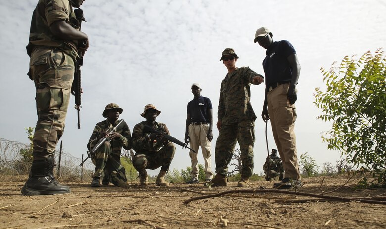 Lance Cpl. Mason Shaw, a combat engineer with Special Purpose Marine Air-Ground Task Force – Crisis Response – Africa, points out an anomaly in the baseline to soldiers with Senegal’s 5th Contingent in Mali during a peacekeeping operations training mission at Thies, Senegal, June 7, 2017. Marines and Sailors with SPMAGTF-CR-AF served as instructors and designed the training to enhance the commandos’ abilities to successfully deploy in support of United Nations peacekeeping missions in the continent. (U.S. Marine Corps photo by Sgt. Samuel Guerra/Released)