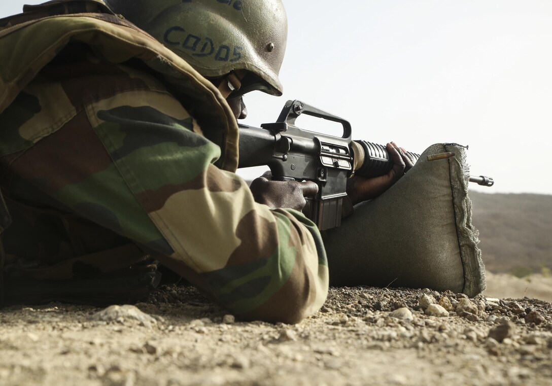 A soldier with Senegal’s 5th Contingent in Mali fires an M16A2 rifle during an unknown distance range as part of a peacekeeping operations training mission alongside U.S. Marines with Special Purpose Marine Air-Ground Task Force – Crisis Response – Africa at Thies, Senegal, June 9, 2017. Marines and Sailors with SPMAGTF-CR-AF served as instructors and designed the training to enhance the soldiers’ abilities to successfully deploy in support of United Nations peacekeeping missions in the continent. (U.S. Marine Corps photo by Sgt. Samuel Guerra/Released)