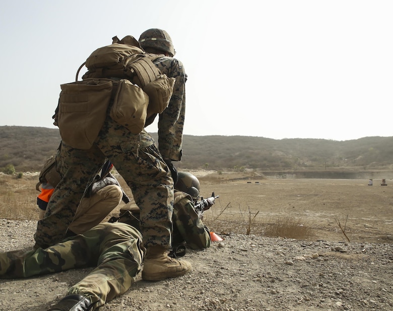 Cpl. Jonah Plemer, a rifleman with Special Purpose Marine Air-Ground Task Force – Crisis Response – Africa, observes the impacts of a soldier with Senegal’s 5th Contingent in Mali during an unknown distance range as part of a peacekeeping operations training mission at Thies, Senegal, June 9, 2017. Marines and Sailors with SPMAGTF-CR-AF served as instructors and designed the training to enhance the soldiers’ abilities to successfully deploy in support of United Nations peacekeeping missions in the continent. (U.S. Marine Corps photo by Sgt. Samuel Guerra/Released)