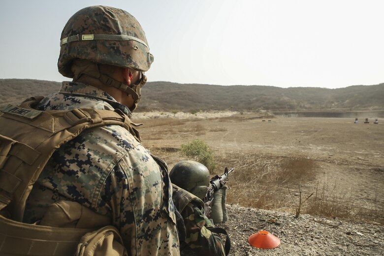 Cpl. Jonah Plemer, a rifleman with Special Purpose Marine Air-Ground Task Force – Crisis Response – Africa, coaches a soldier with Senegal’s 5th Contingent in Mali through an unknown distance range course of fire during a peacekeeping operations training mission at Thies, Senegal, June 9, 2017. Marines and Sailors with SPMAGTF-CR-AF served as instructors and designed the training to enhance the soldiers’ abilities to successfully deploy in support of United Nations peacekeeping missions in the continent. (U.S. Marine Corps photo by Sgt. Samuel Guerra/Released)