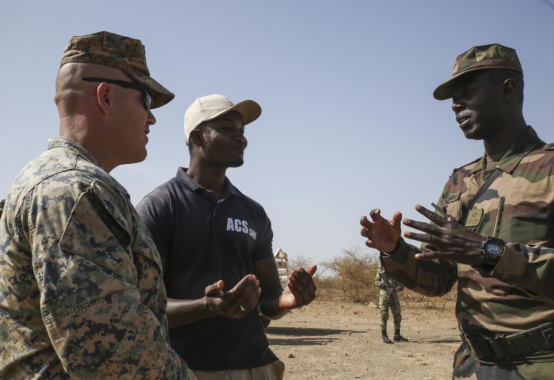 Sgt. Joshua Horne, a rifleman with Special Purpose Marine Air-Ground Task Force – Crisis Response – Africa, aides in describing a scenario during the final exercise of a peacekeeping operations training mission at Thies, Senegal, June 13, 2017. Marines and Sailors with SPMAGTF-CR-AF served as instructors and designed the training to enhance the soldiers’ abilities to successfully deploy in support of United Nations peacekeeping missions in the continent. (U.S. Marine Corps photo by Sgt. Samuel Guerra/Released)