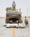 U.S. Air Force Staff Sgt. David Wakeman, laying down, airfield operator, and Master Sgt. Ricky Johnson, airfield superintendent, both assigned to the 557th Expeditionary RED HORSE Squadron, inspect a low-boy trailer and excavator before unloading the equipment on the runway at Al Udeid Air Base, Qatar, Aug. 7, 2017. The 557th ERHS loaded the 50,000 pound excavator into a C-17 Globemaster III aircraft for transportation to an undisclosed location in the U.S. Central Command Area of Responsibility. (U.S. Air National Guard photo by Tech. Sgt. Bradly A. Schneider/Released)