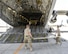 U.S. Air Force Staff Sgt. Leigh Sullivan, right, and Senior Airman Jonathan Moore, members of the cargo movement team assigned to the 557th Expeditionary RED HORSE Squadron lay plywood to protect a C-17 Globemaster III prior to loading an excavator onto the aircraft at Al Udeid Air Base, Qatar, Aug. 7, 2017. Members of the 557th ERHS loaded the 50,000 pound excavator into a C-17 Globemaster III aircraft for transportation to an undisclosed location in the U.S. Central Command Area of Responsibility. (U.S. Air National Guard photo by Tech. Sgt. Bradly A. Schneider/Released)