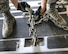 A chain used to secure cargo inside a U.S. Air Force C-17 Globemaster III is fastened to the floor of the aircraft at Al Udeid Air Base, Qatar, Aug. 7, 2017. Chains were used to secure a Light Medium Tactical Vehicle and a 50,000 pound excavator into a C-17 Globemaster III for transportation to an undisclosed location in the U.S. Central Command Area of Responsibility. (U.S. Air National Guard photo by Tech. Sgt. Bradly A. Schneider/Released)