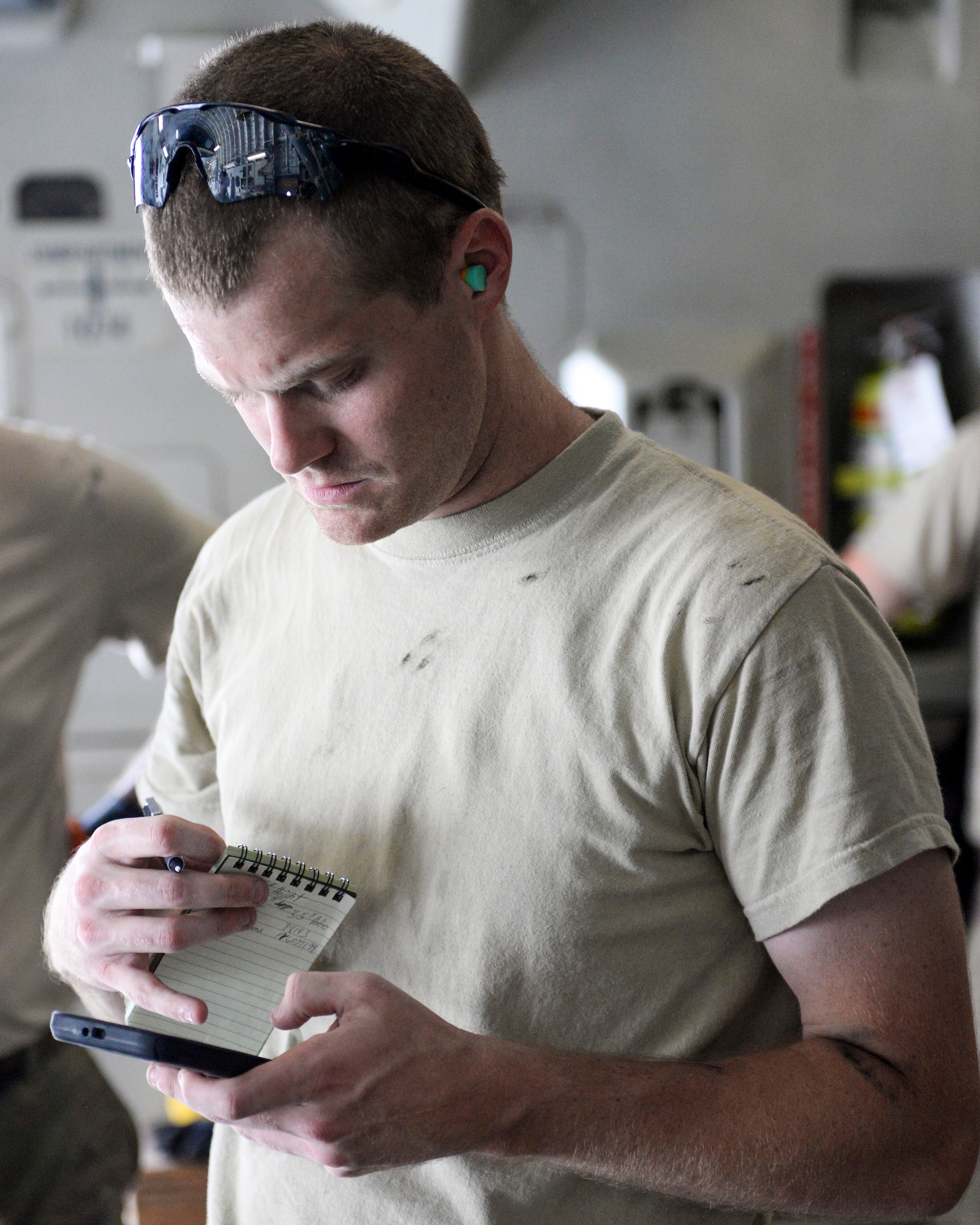 U.S. Air Force Senior Airman Jace Fore, air transportation craftsman assigned to the 8th Expeditionary Air Mobility Squadron, completes calculations to ensure proper load position of cargo inside a C-17 Globemaster III at Al Udeid Air Base, Qatar, Aug. 7, 2017.
