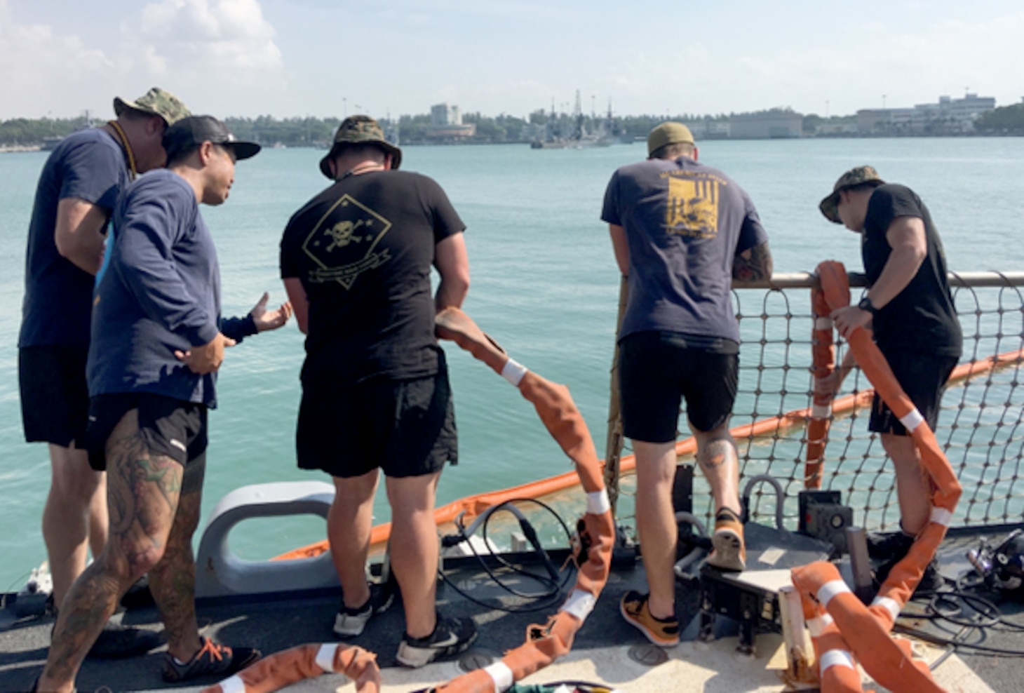 U.S. Navy and Marine Corps divers provide support to the USS John S. McCain (DDG 56) at Changi Naval Base, Singapore Aug. 23, 2017. The McCain sustained significant damage following a collision with the merchant vessel Alnic MC while underway east of the Strait of Malacca and Singapore on Aug. 21, 2017.