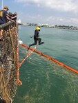 A U.S. Navy diver enters  the water while conducting diving operations in support of USS John S. McCain (DDG 56) at Changi Naval Base, Singapore Aug. 23, 2017. The McCain sustained significant damage following a collision with the merchant vessel Alnic MC while underway east of the Strait of Malacca and Singapore on Aug. 21, 2017.